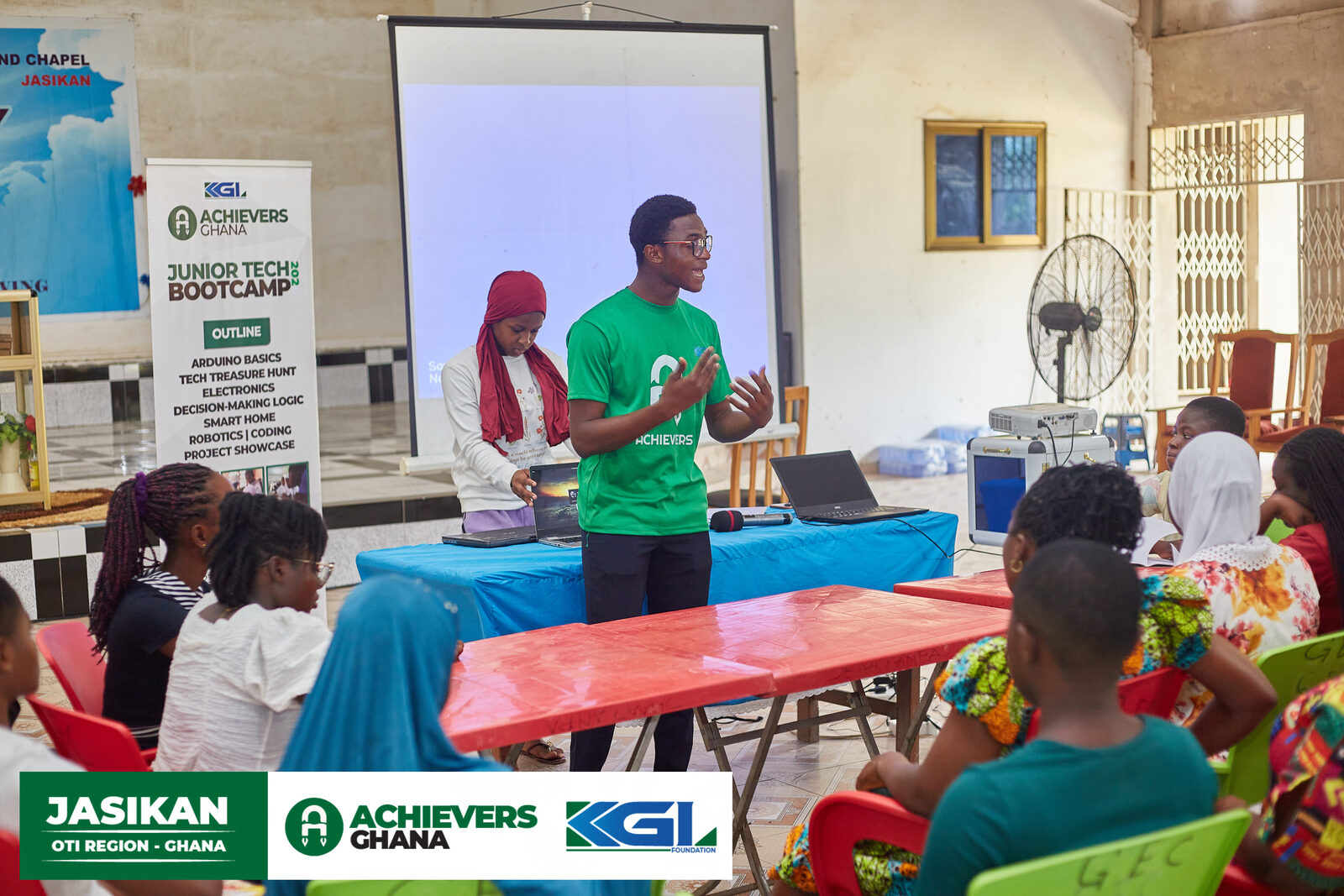 A student and mentor reviewing an accountability chart at Achievers Ghana